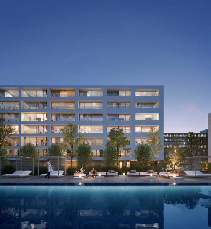 Modern mixed-use residential towers at dusk — Aljada